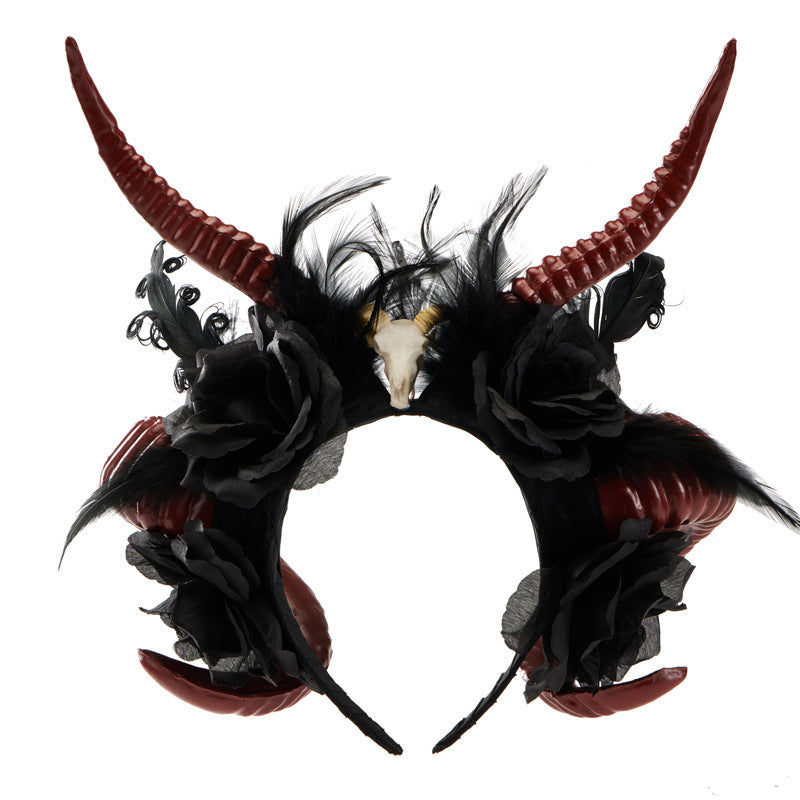 Headband with red horns, black feathers, and flowers on a white background