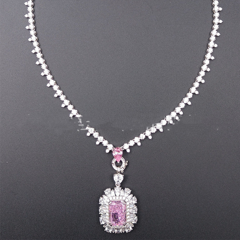Necklace with a pink gemstone pendant on a dark background