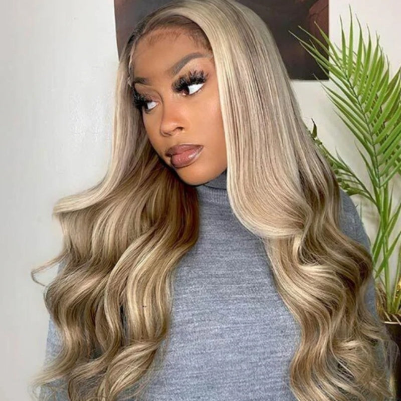 Woman with long, wavy, two-tone hair in a gray sweater.