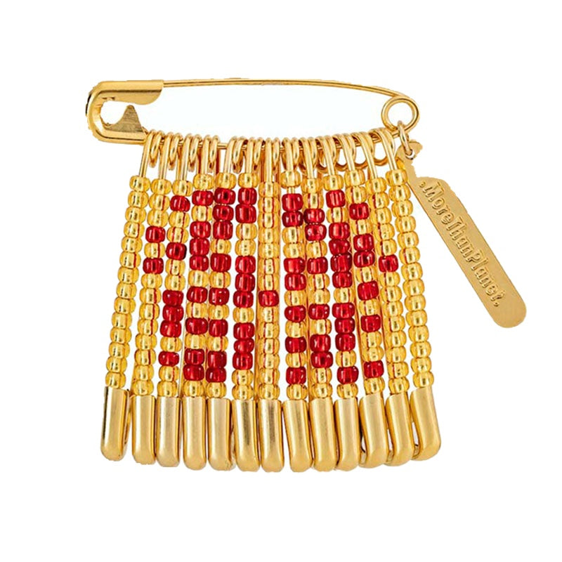 Gold and red beaded brooch with a gold tag on a white background