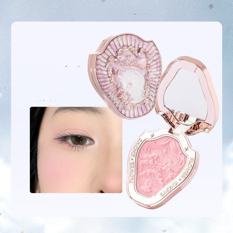 Pink blush compact with heart design and a close-up of a person applying it.