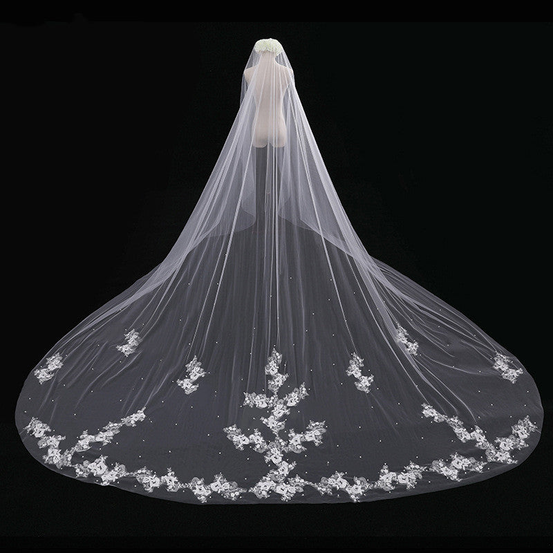 White wedding veil with floral lace edge on a black background