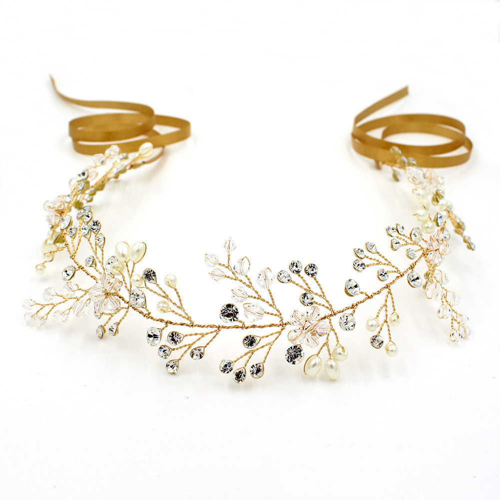 Gold headband with pearls and crystals on a white background