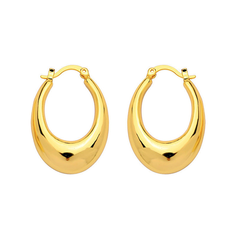 Gold hoop earrings on a white background