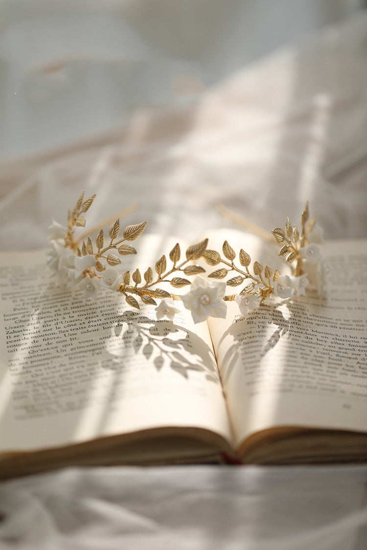 Gold leaf headband on an open book with a soft focus background