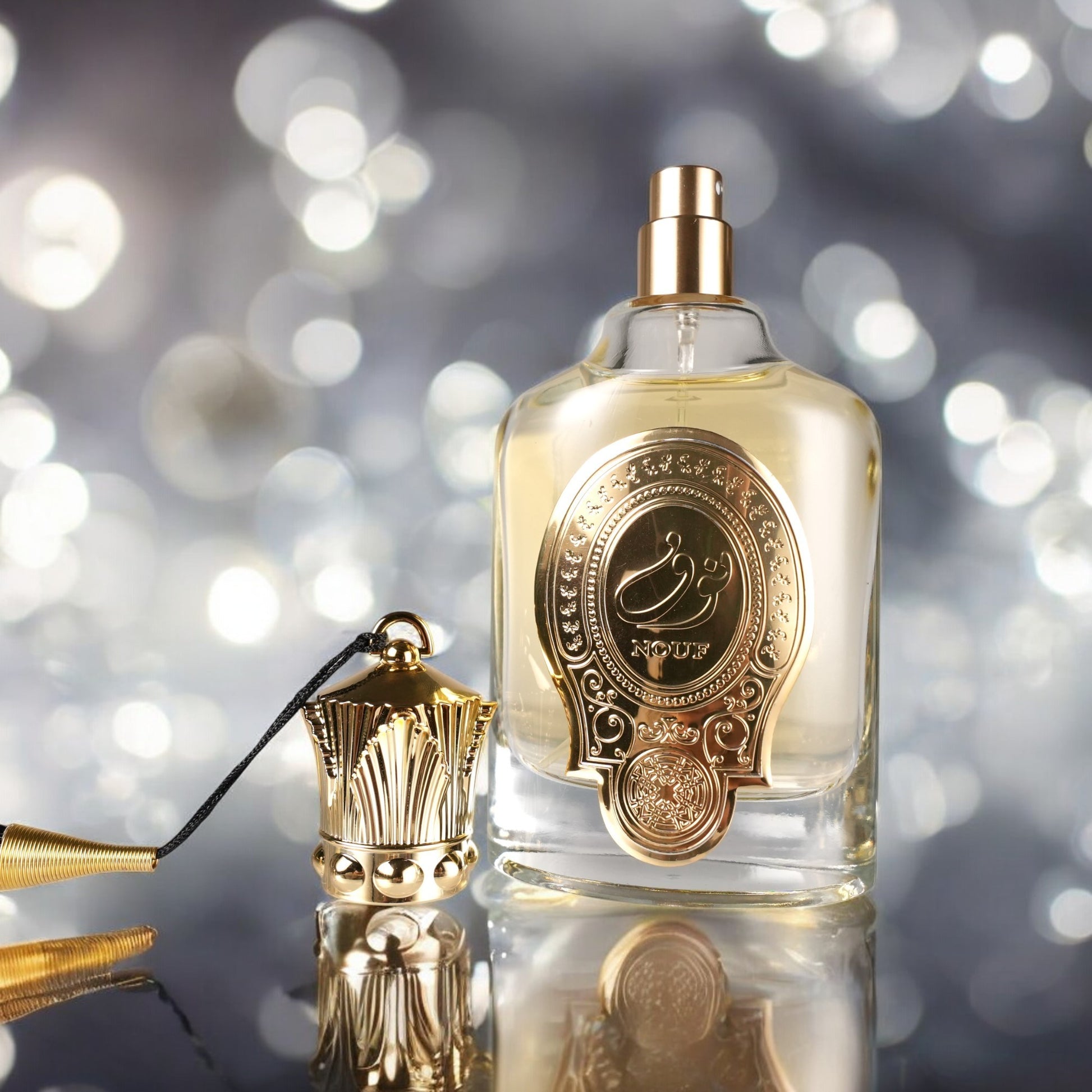 Perfume bottle with gold cap and decorative label on a reflective surface with blurred lights in the background