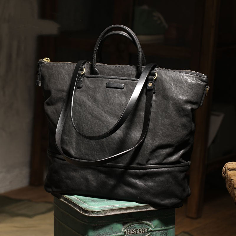 Black leather handbag on a wooden surface with a blurred background