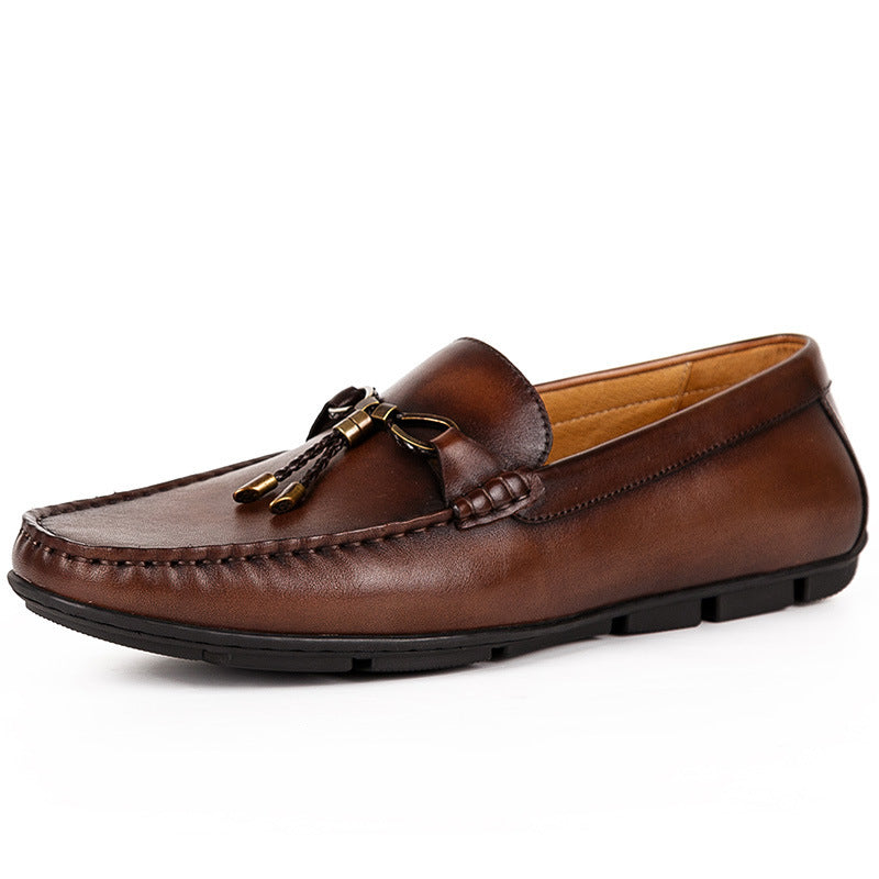 Brown leather loafer with a decorative buckle on a white background