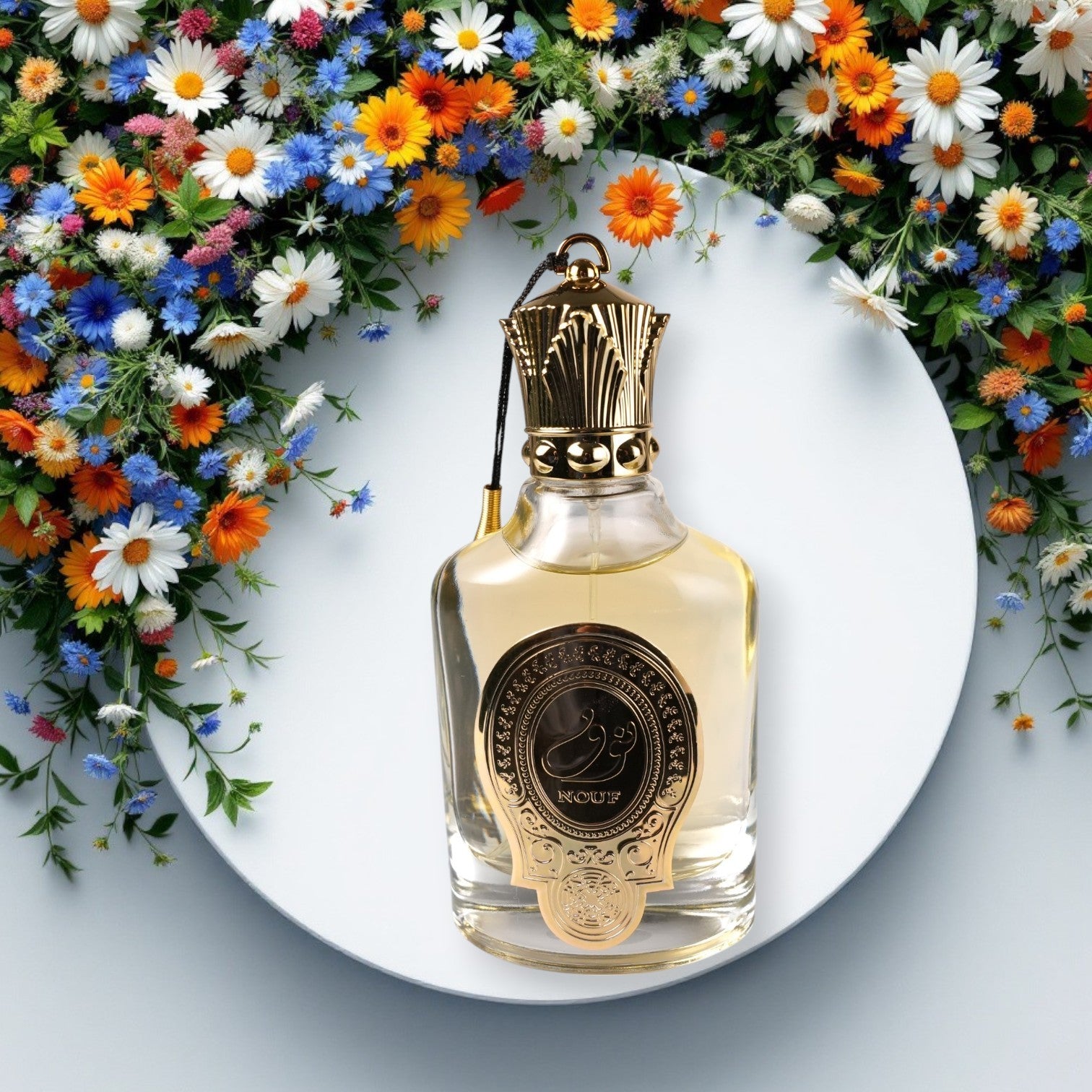 Perfume bottle with gold cap on a white plate surrounded by colorful flowers