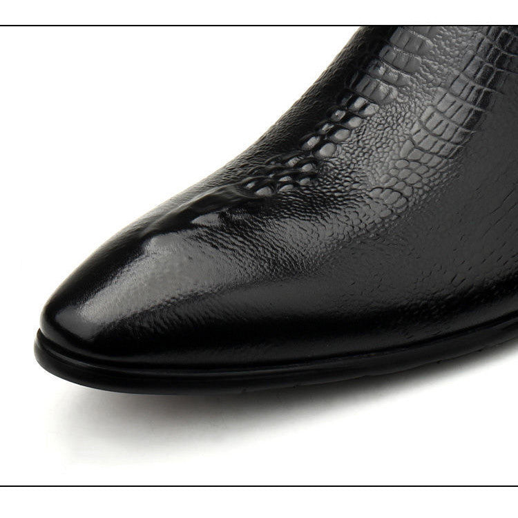 Close-up of a black leather shoe with pointed toe on a white background