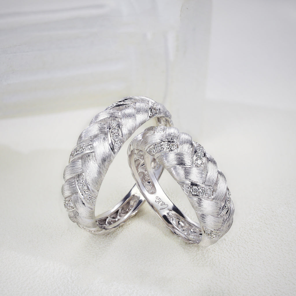 Two silver rings with diamond accents on a white background