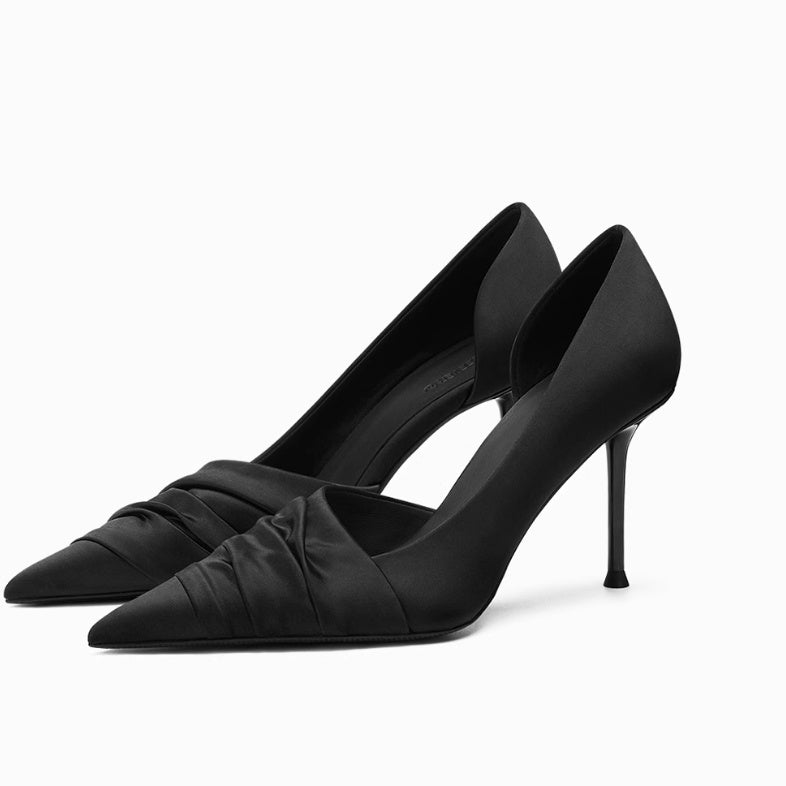 Pair of black high-heeled shoes on a white background