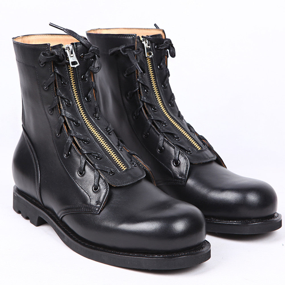 Black leather boots with gold zippers on a white background