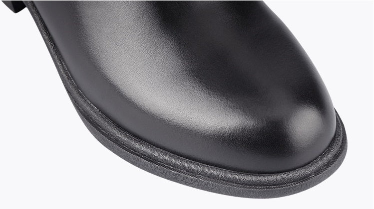 Close-up of a black leather boot sole on a white background