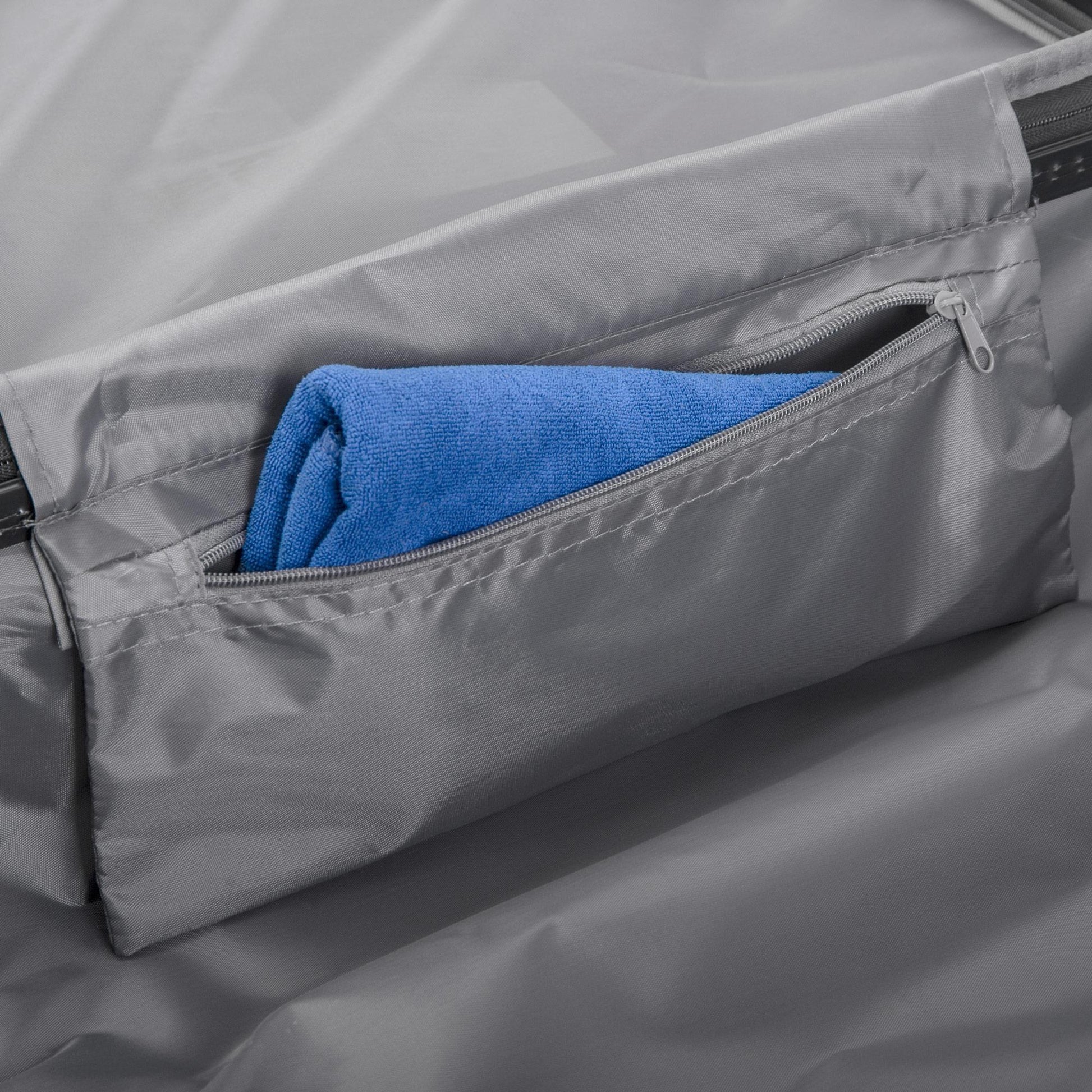 Gray car sunshade with a blue towel inside