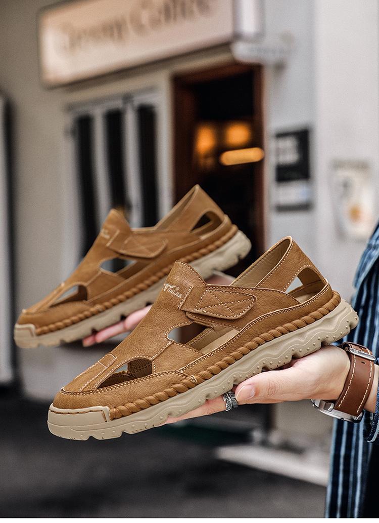 Brown sandals held by a person with a blurred indoor background