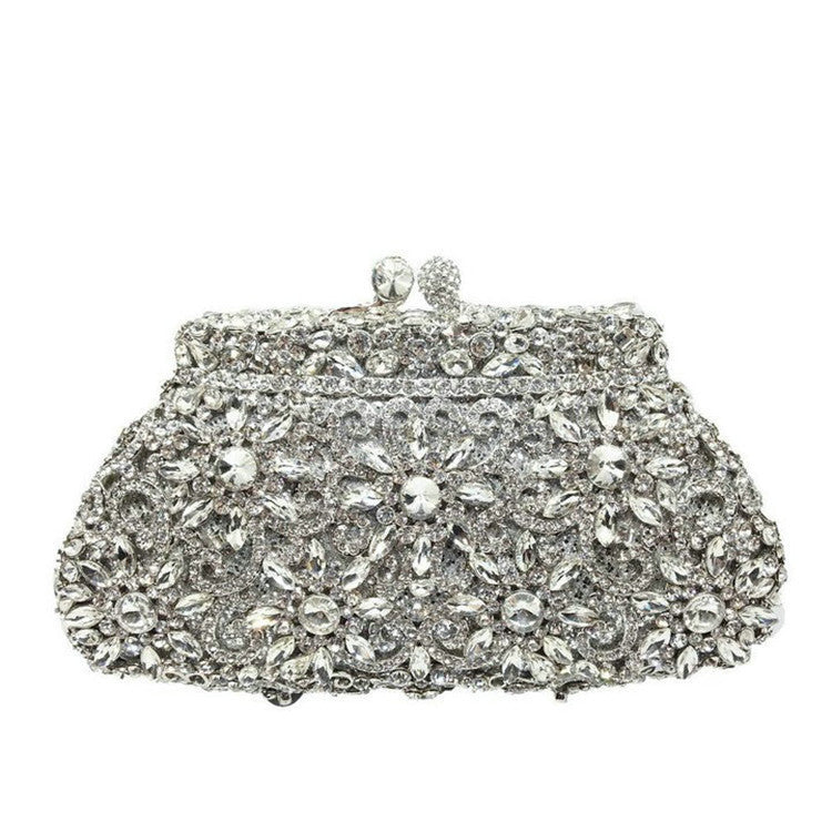 Silver clutch bag with intricate gemstone detailing on a white background