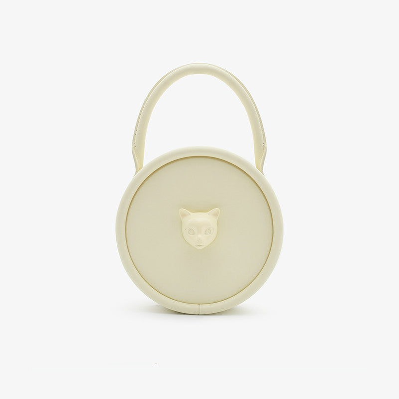 Round beige container with a handle on a white background