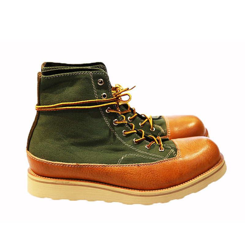 Green and brown boots with yellow laces on a white background
