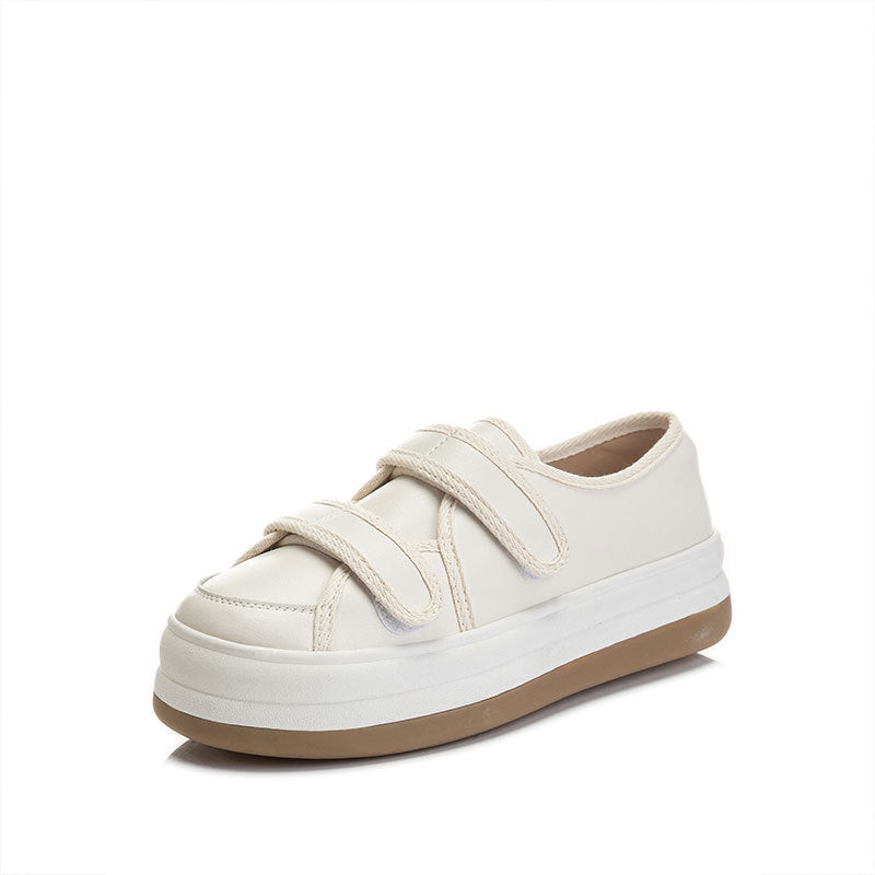 White sneaker with velcro straps on a white background