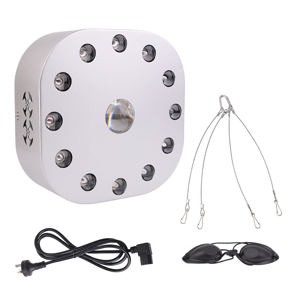 White electronic device with multiple lights, a power cord, and goggles on a white background