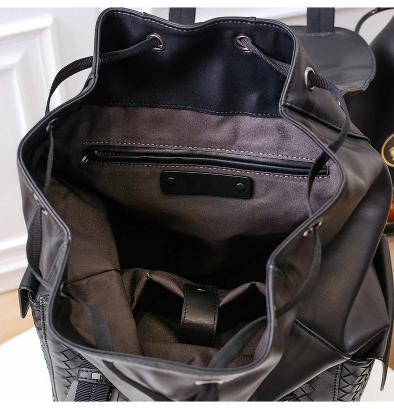 Black backpack with open front compartment showing interior details.