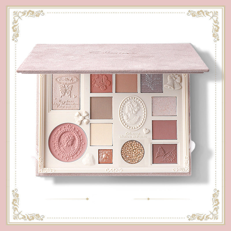 Makeup palette with decorative design on a light pink background