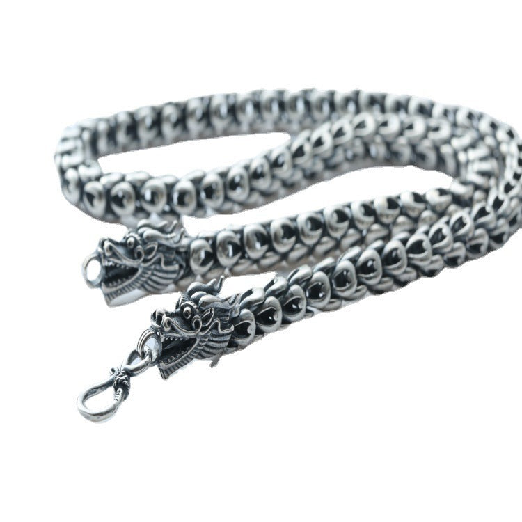 Silver chain with dragon clasp on a white background