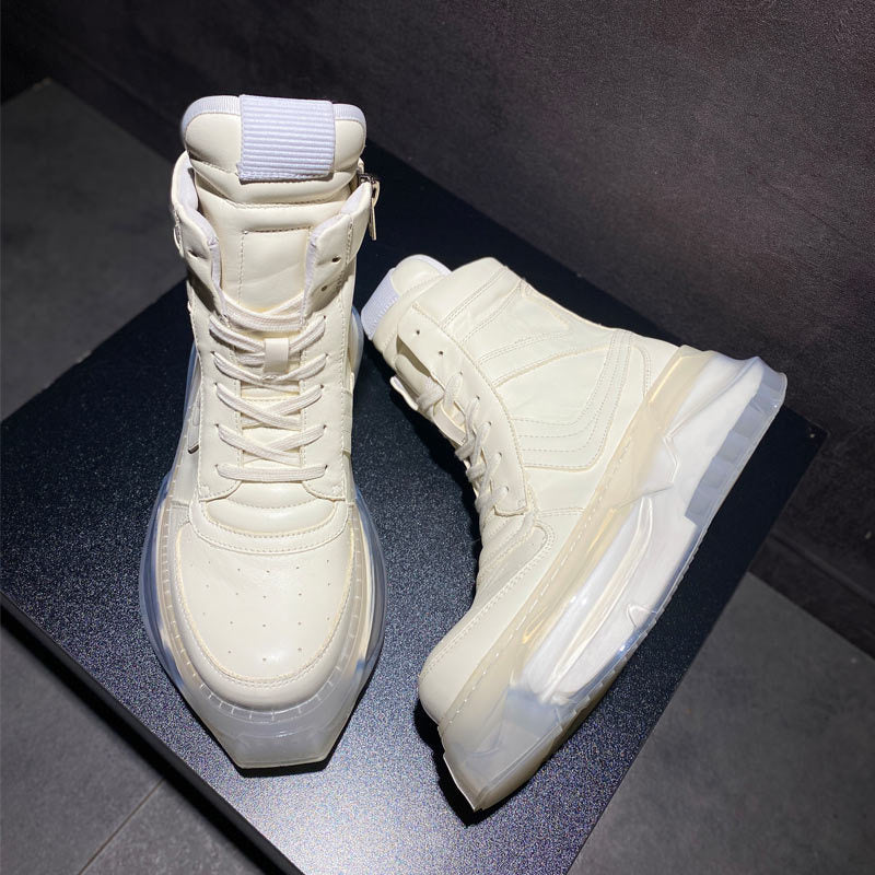 Pair of white high-top sneakers on a dark surface