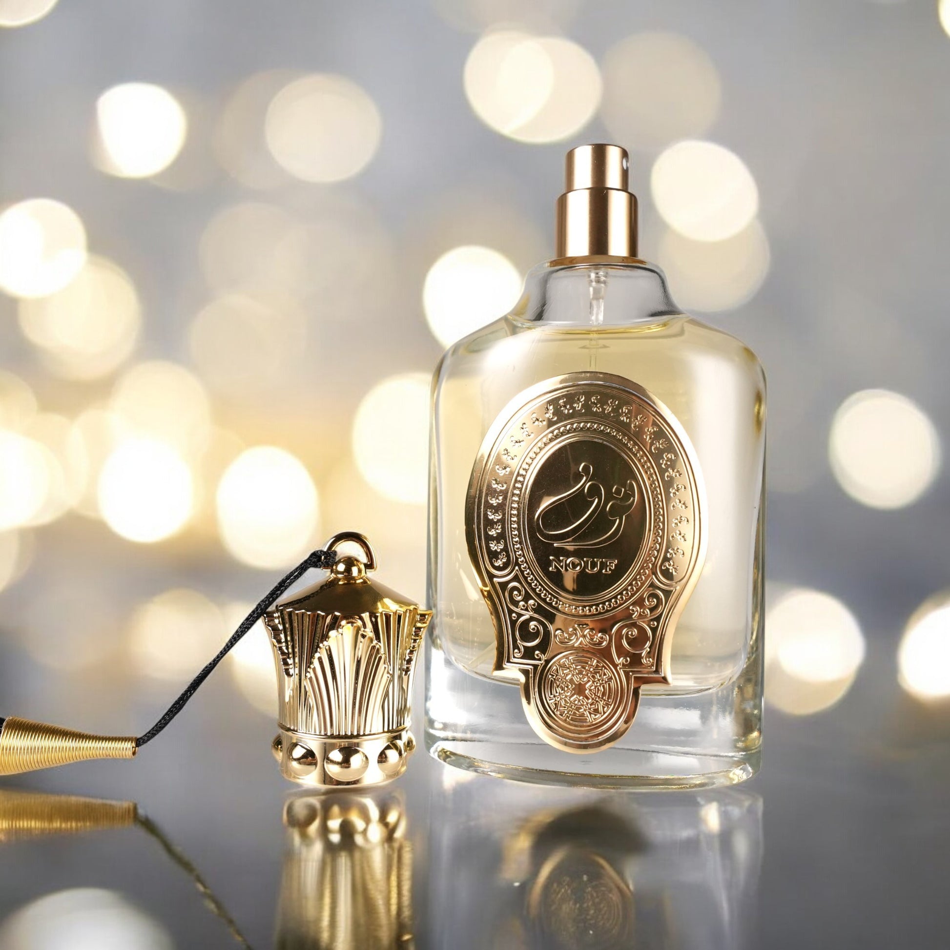 Perfume bottle with gold cap and decorative label on a blurred lights background