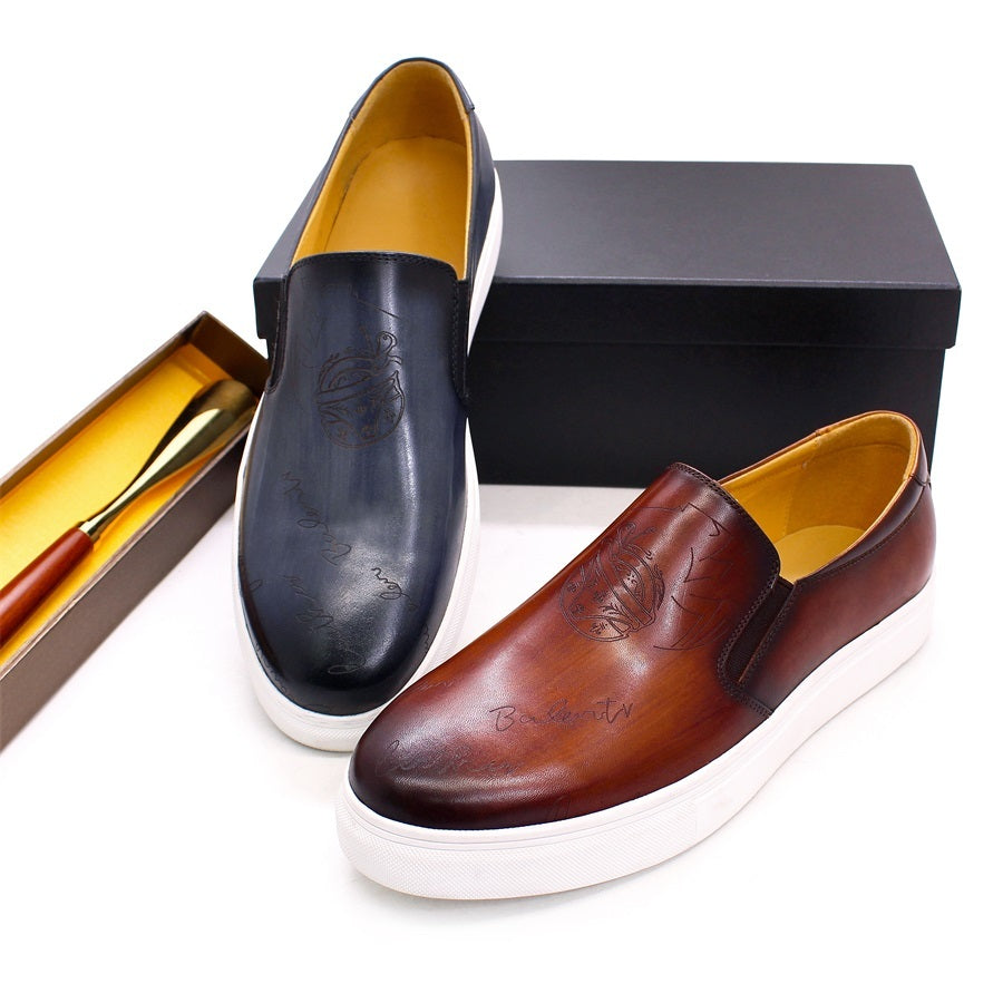 Pair of black and brown leather shoes with a box on a white background