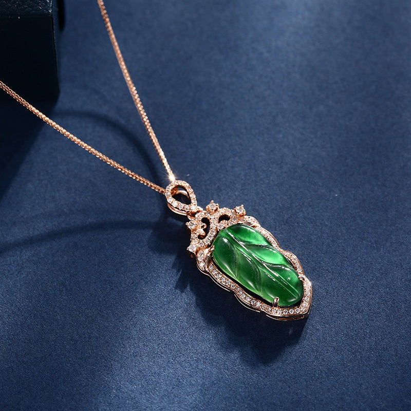 Green jade pendant necklace on a blue background