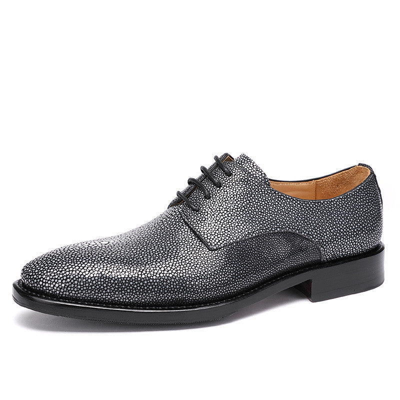 Gray textured dress shoe on a white background