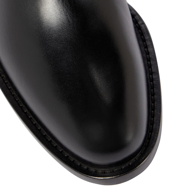 Close-up of a black leather boot sole on a white background
