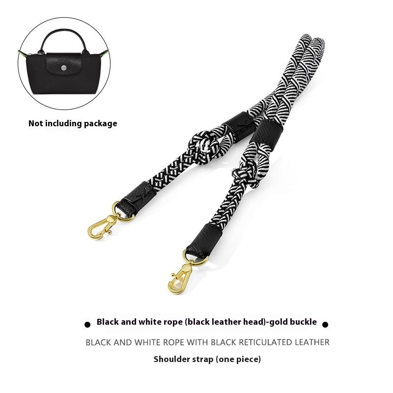 Black and white rope shoulder strap with gold buckle on a white background