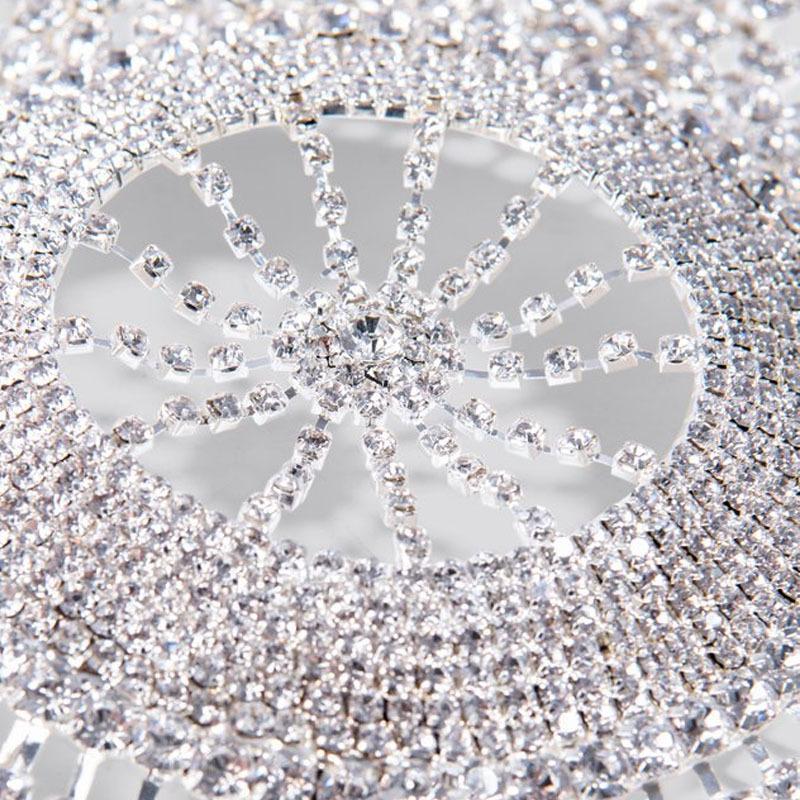 Close-up of a decorative sand dollar with rhinestones on a glittery background