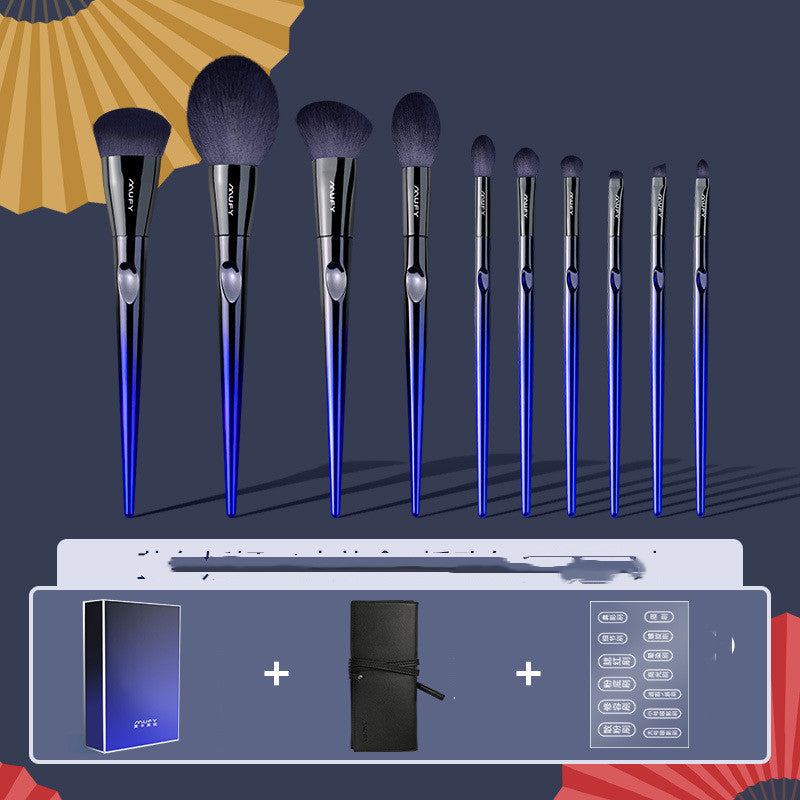Set of makeup brushes with blue handles and black bristles, displayed against a dark background.
