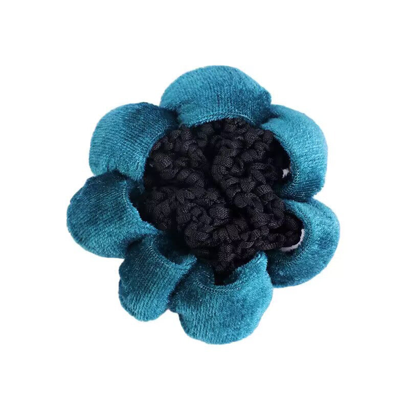 Blue and black flower-shaped object on a white background