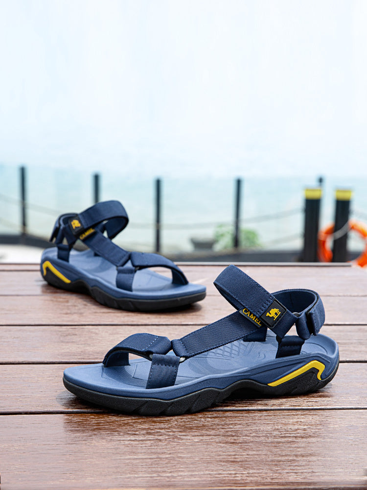 Blue sandals with yellow accents on a wooden surface