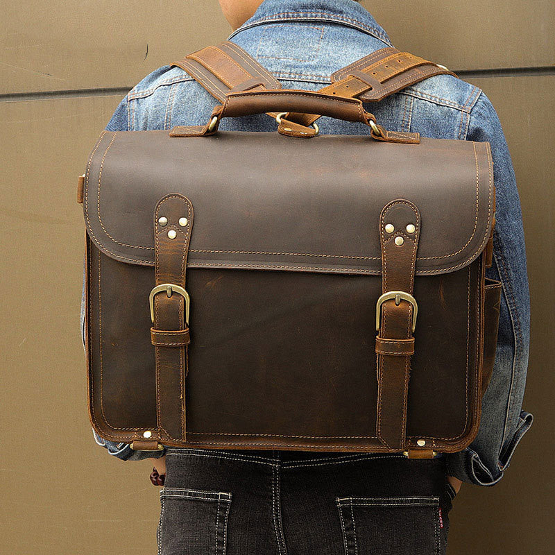 Brown leather backpack worn by a person against a beige background