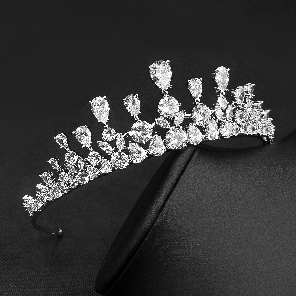 Diamond tiara on a black stand against a black background