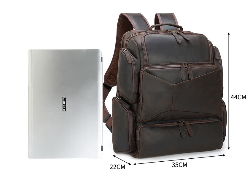 Brown leather backpack next to a laptop with dimensions indicated