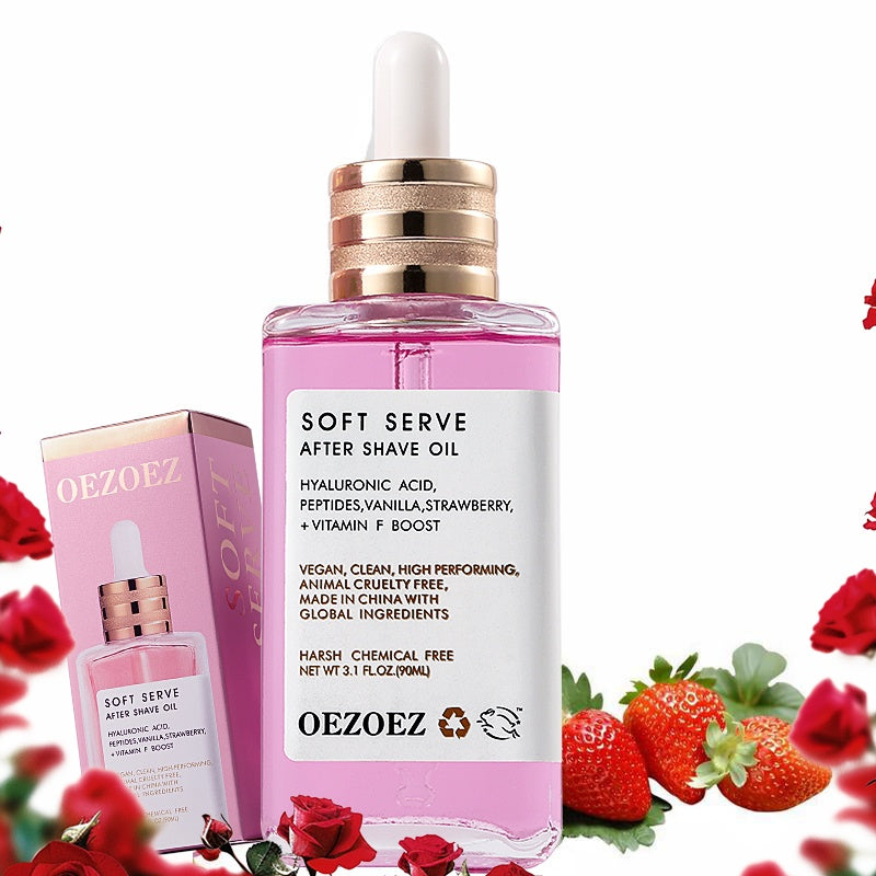 Pink bottle of Oezoez Soft Serve After Shave Oil with packaging and strawberries in the background