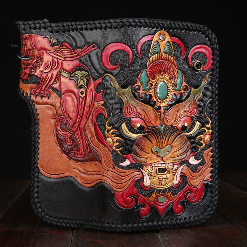 Decorative leather wallet with intricate designs on a dark background