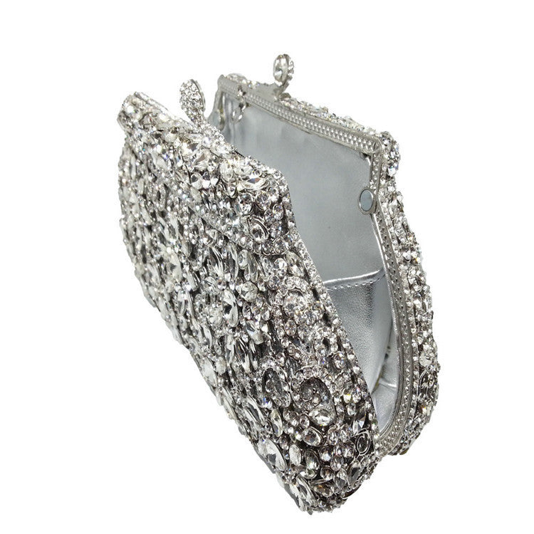 Elegant silver clutch bag with intricate detailing on a white background