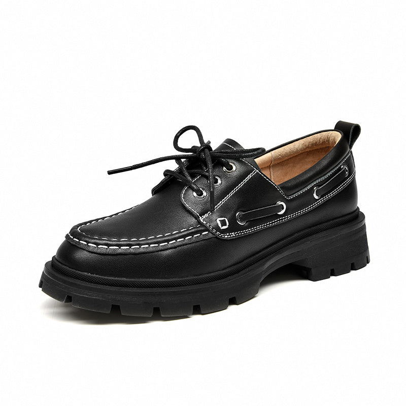 Black leather boat shoe with thick sole on a white background