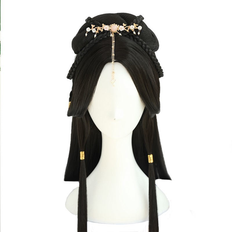 Black wig with decorative headband on a mannequin head against a white background