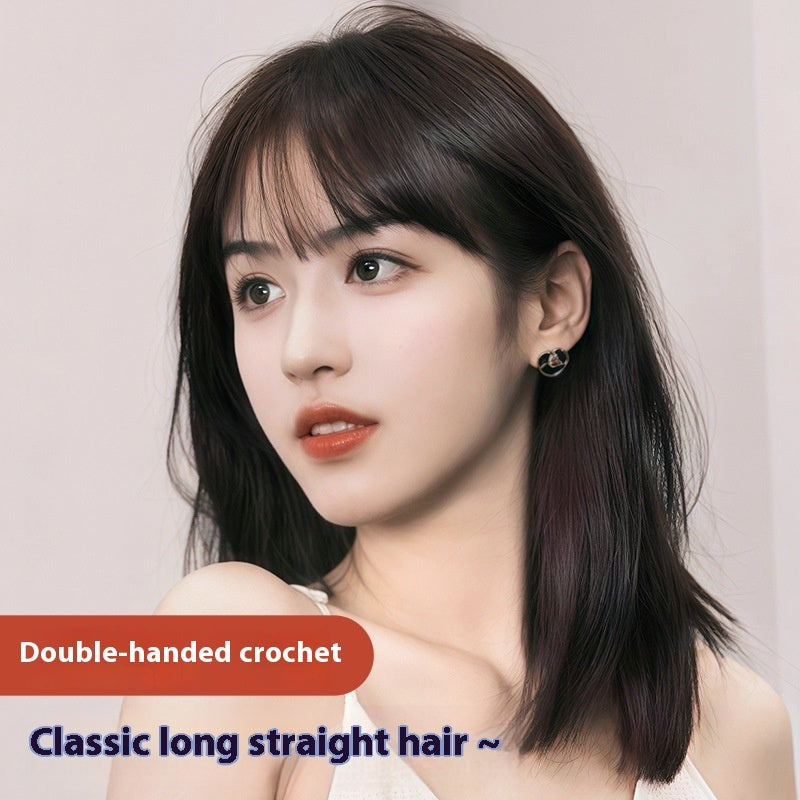 Woman with classic long straight hair against a plain background