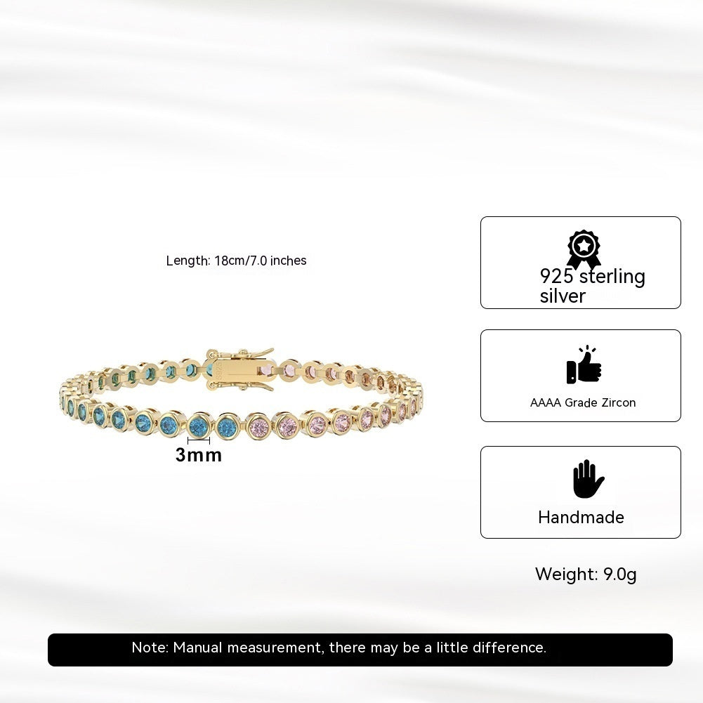Gold bracelet with colorful stones on a white background, showing product details.