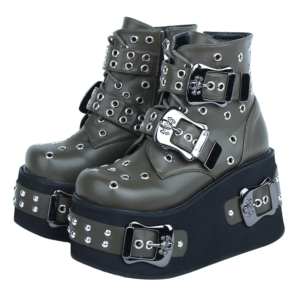 Pair of green platform boots with buckles and studs on a white background